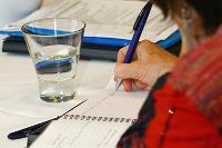 Woman takes down notes in a book