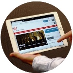 A man holds an iPad with the AEF homepage u