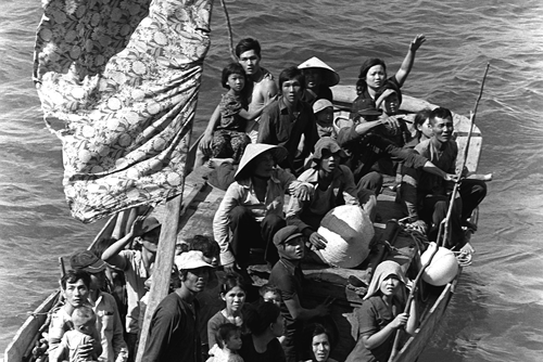 Black and white image of Vietnamese refugees crowded on a boat
