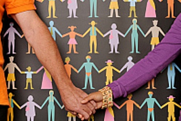 Two people hold hands