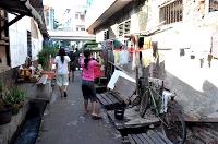 A narrow street with small canals on either side