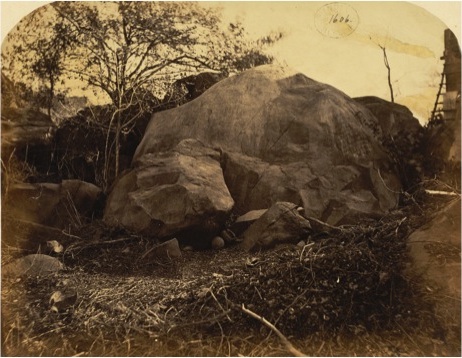 Brahmi script engraved into a rock face