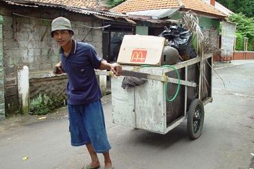 Man takes away garbage from a street
