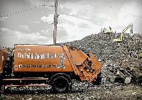 Orange rubbish truck in Indonesia