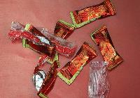 A pile of red, empty plastic wrappers