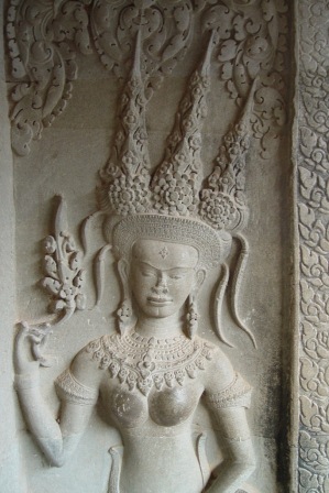 Close-up of a bas-relief of an Angkor dancer wearing an ornate headdress and jewellrya