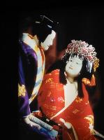 The female Banraku puppet looks up at the male Banraku puppet