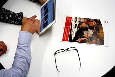 A man and woman use an iPad