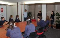 7 students sitting around a board table listening to HSBC staff talk